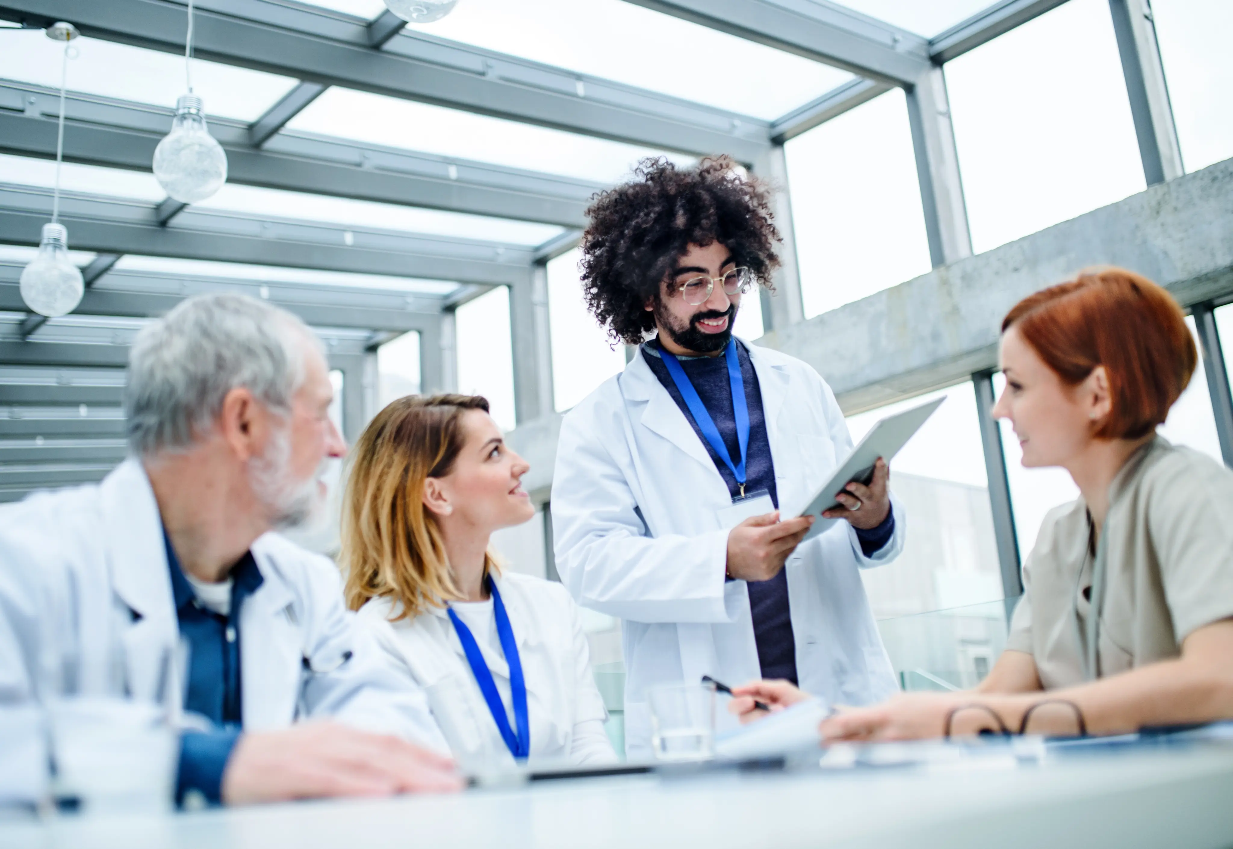 Healthcare team discussing on tablet